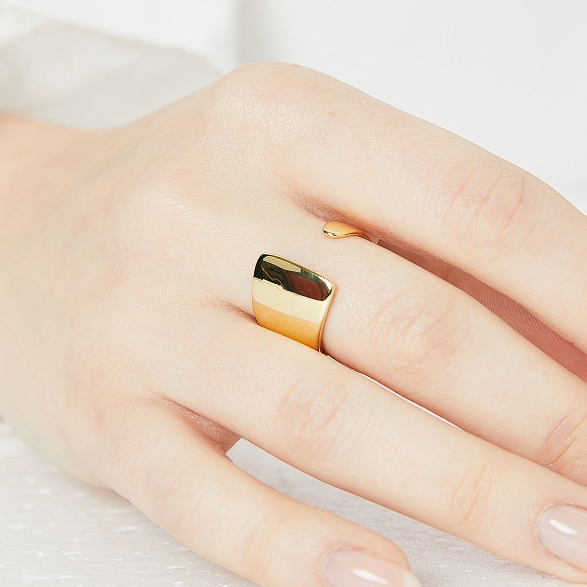 close worn view of the broad gold plated sculptural ring
