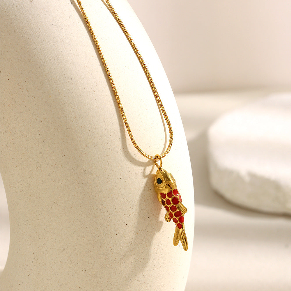 Red red scale-pattern fish necklace on a display form