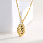 close angled view of diagonal ribs across the oval pendant