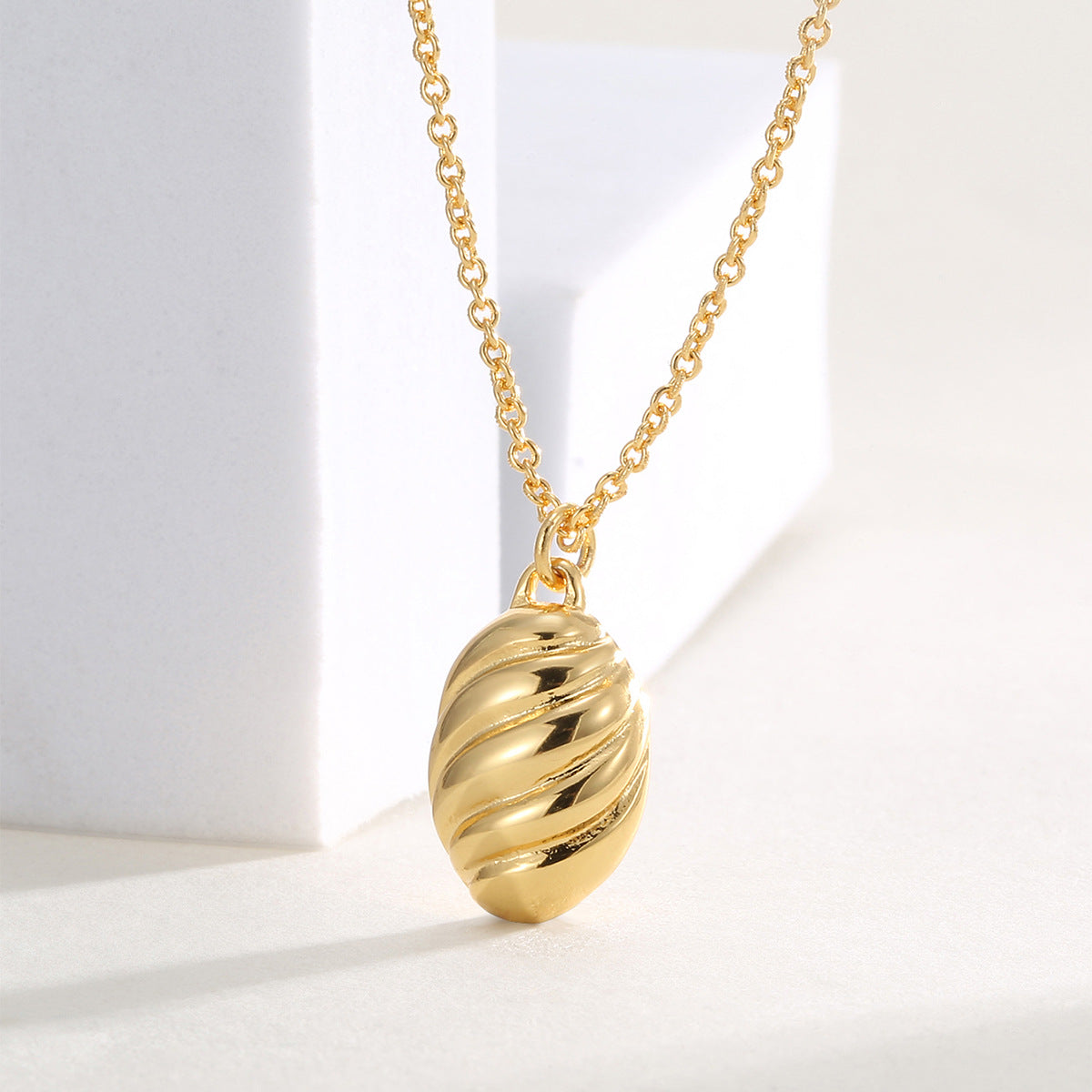 close angled view of diagonal ribs across the oval pendant