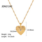 Textured heart pendant with a small clear center and size labels