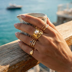 Textured pearl-look ring worn beside the sea