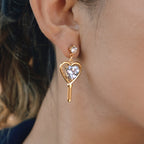 side view of mismatched gold plated heart drop earrings
