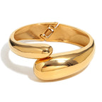 front view of chunky gold plated twin snake-head bangle