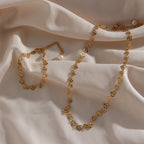heart-link necklace and bracelet arranged together on satin