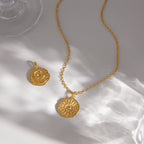 Medallion necklace with reverse face visible
