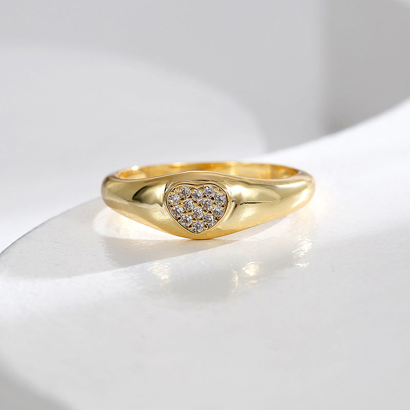 front angle of zirconia heart ring on a white display surface