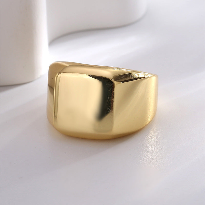 side profile of smooth rounded-square brass signet ring