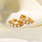mismatched stainless steel pearl hoops arranged on satin