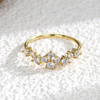 front view of staggered clear stones across a slim gold plated band