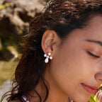 Cross stud with white accents worn on a model