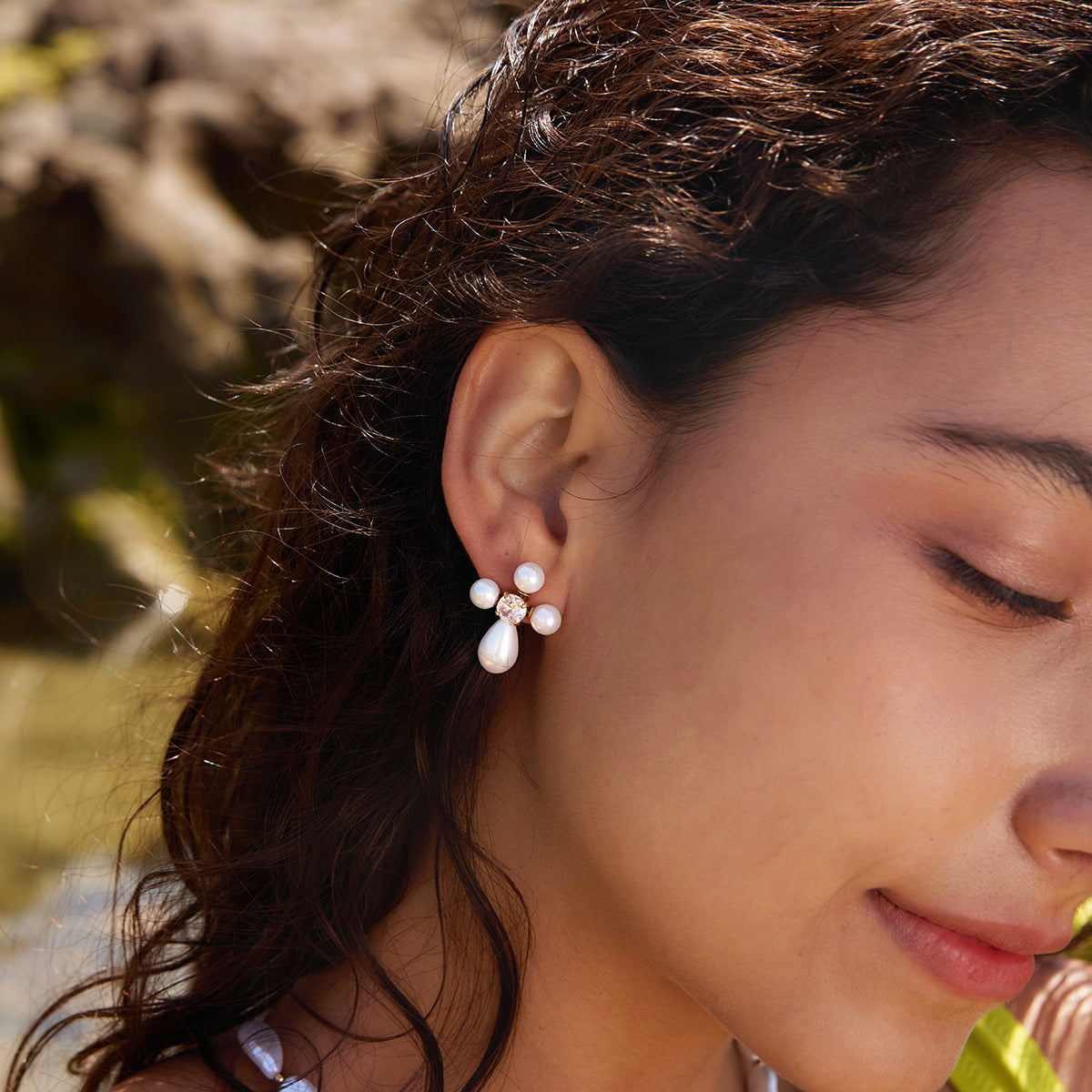 Cross stud with white accents worn on a model