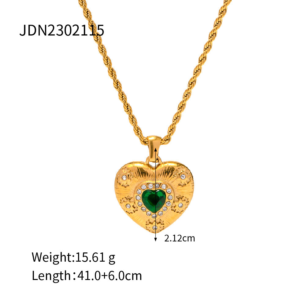 Gold-tone heart pendant necklace with a green center accent
