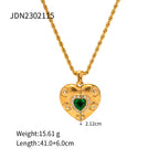 Gold-tone heart pendant necklace with a green center accent