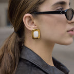 Gold tone rectangle stud worn with sunglasses