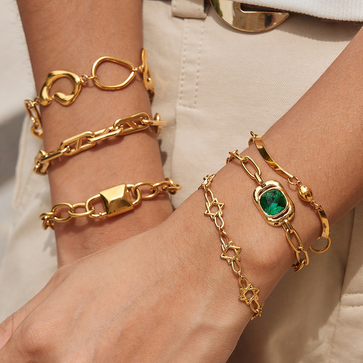 Gold-tone chain bracelets worn on both wrists