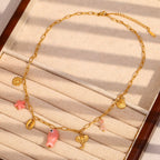 gold plated coastal necklace arranged with pink decorative accents
