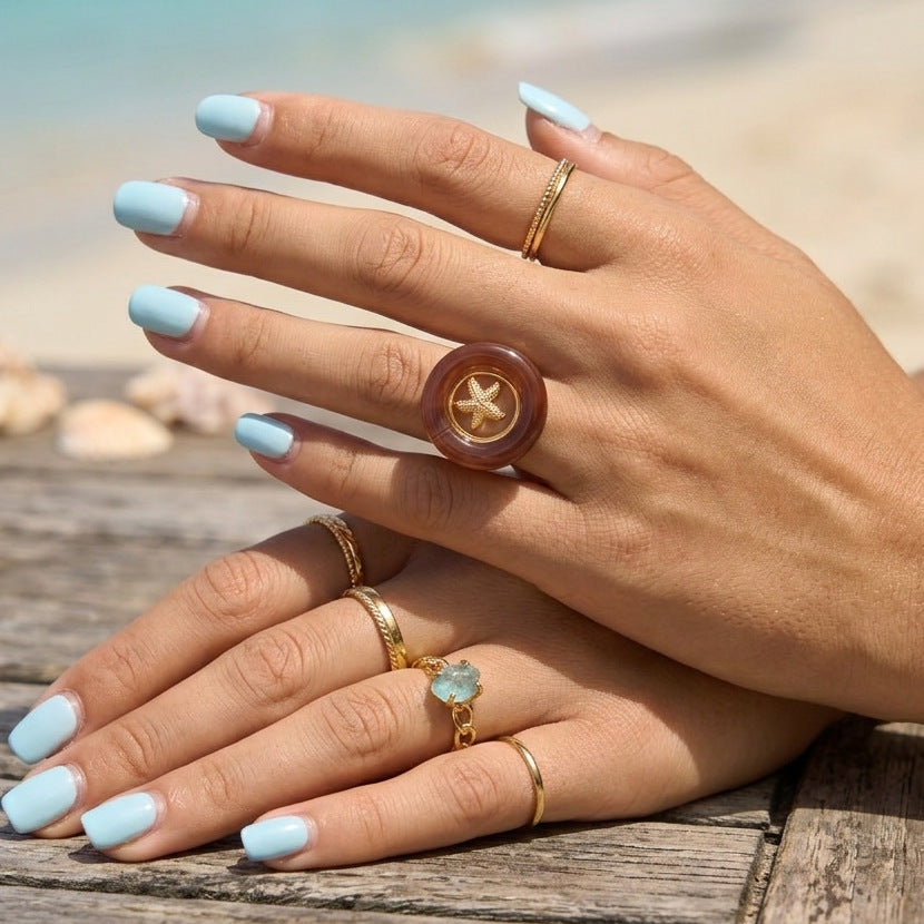 Coastal statement ring styled with other rings