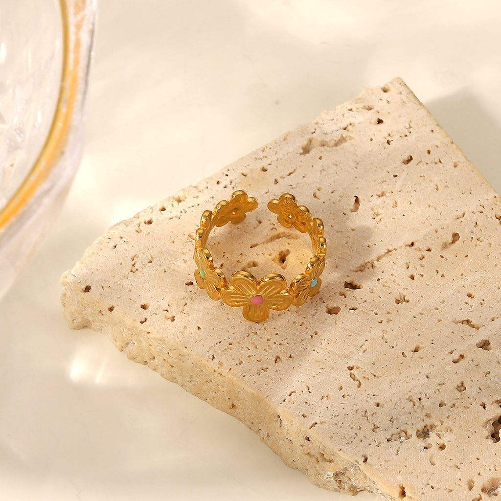Floral garland ring with colored centers on a stone block