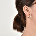 gold plated clear zirconia hoop earrings worn on the ear