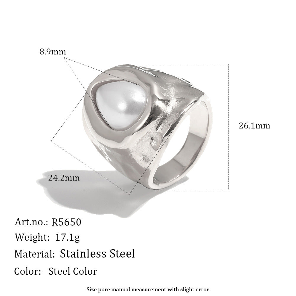 Silver tone ring showing hammered surface and white pearlescent setting