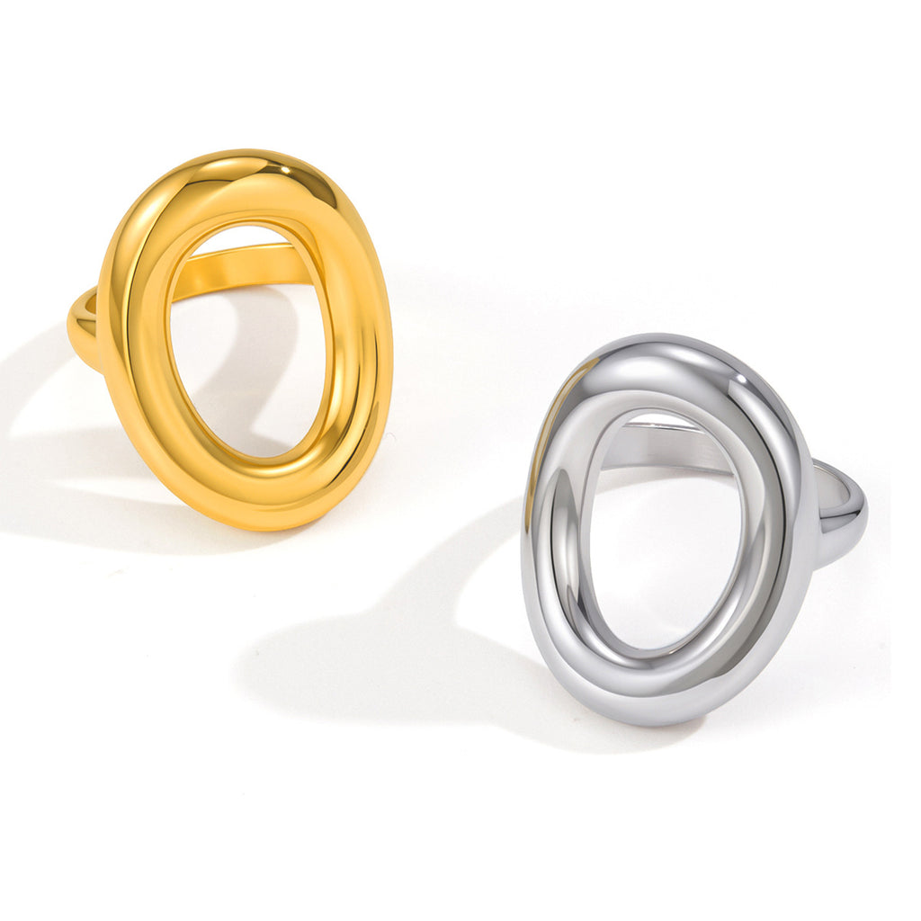 Gold and steel color oval statement rings on white