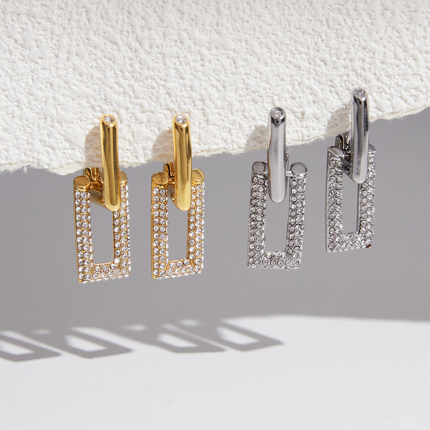 Two finishes of rectangular frame earrings hanging together