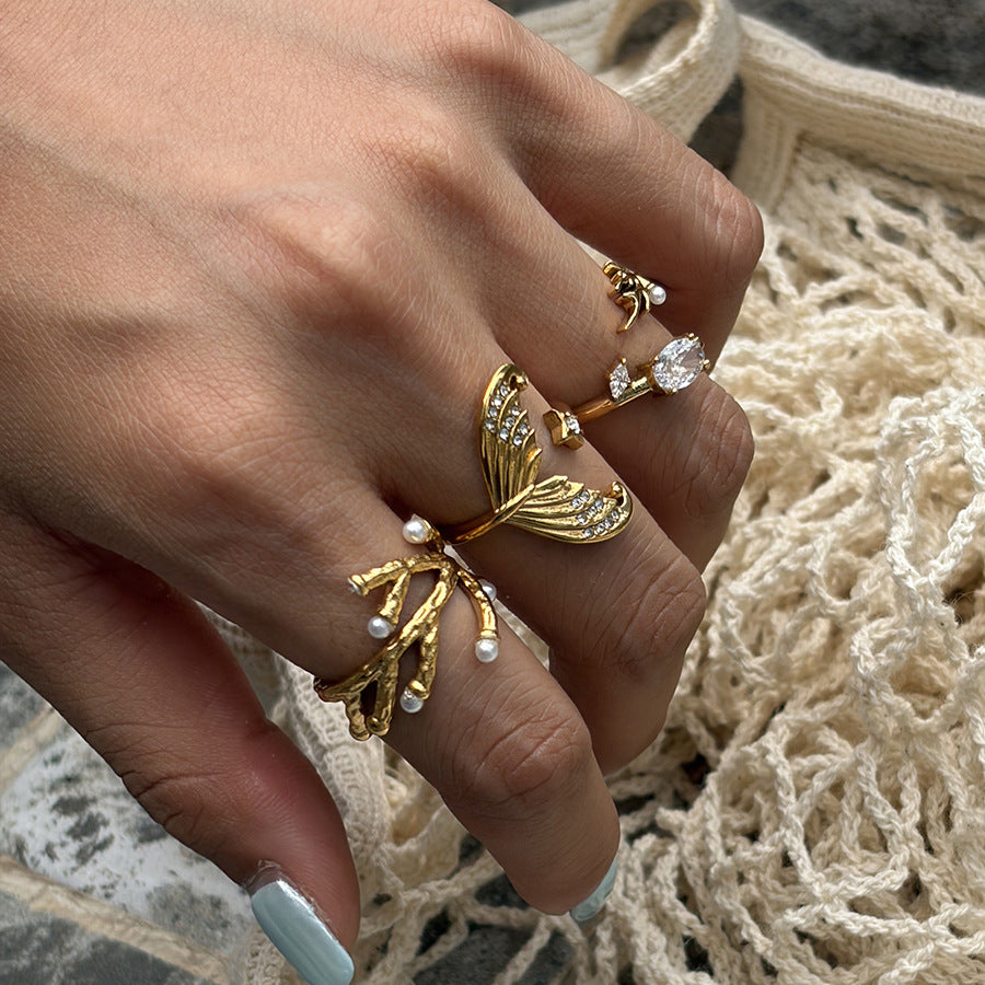 Branch ring with white bead tips on a hand