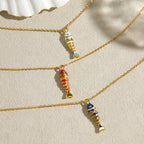 White blue and red fish pendants on a neutral surface