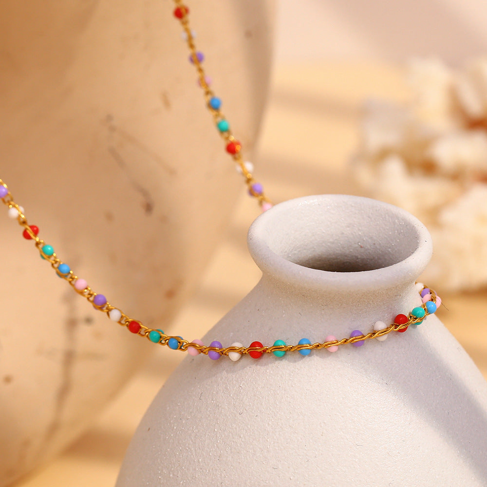 Multicolor bead stainless steel necklace shown on a display bust