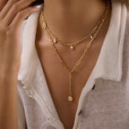Charm necklace and round stone lariat shown together on model