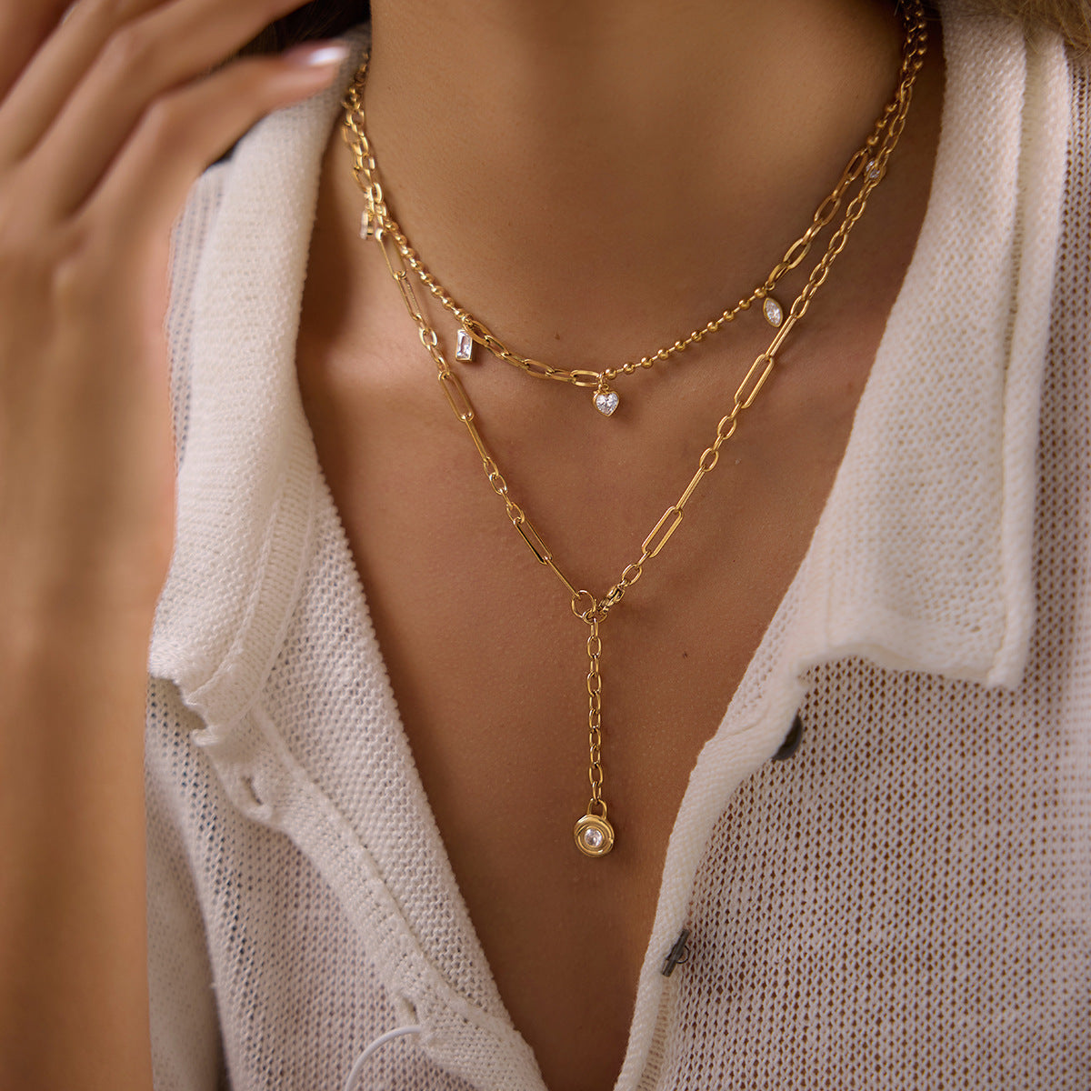 Charm necklace and round stone lariat shown together on model