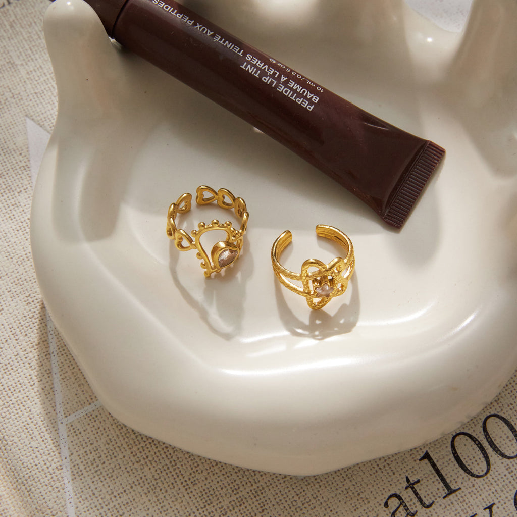 Open backs of two decorative rings on a tray