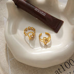 Open backs of two decorative rings on a tray