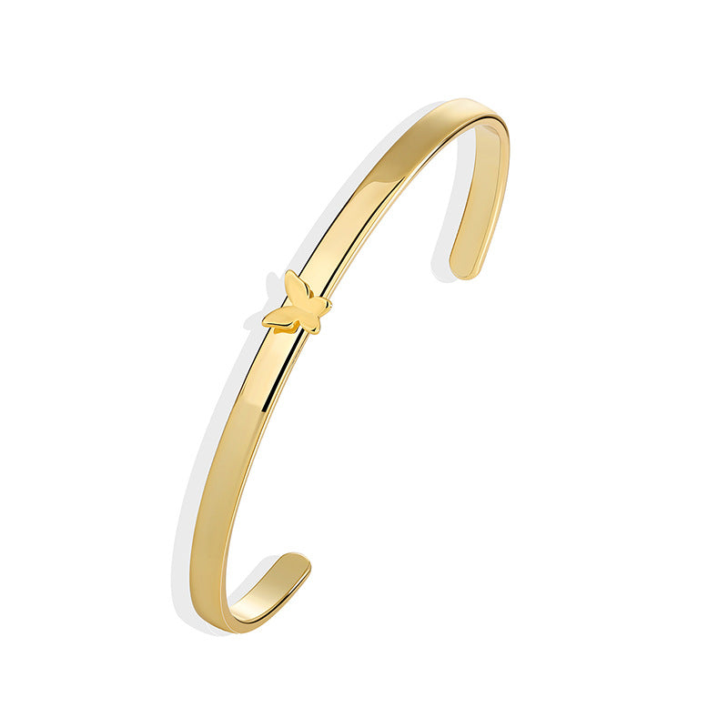 isolated gold plated butterfly cuff with rounded open ends