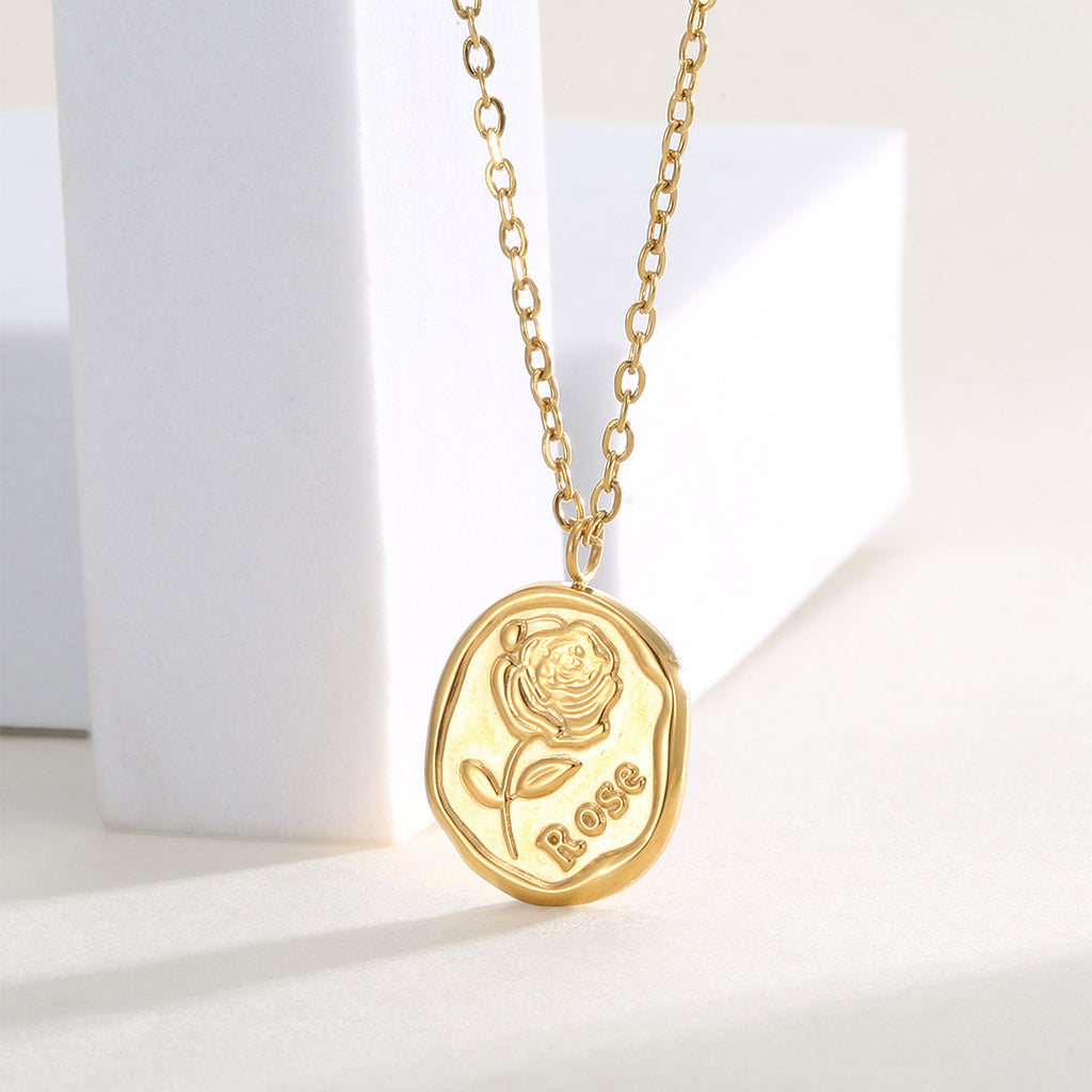 angled view of the raised rose relief pendant and fine chain