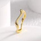 side profile showing the widened curves of the sculptural ring