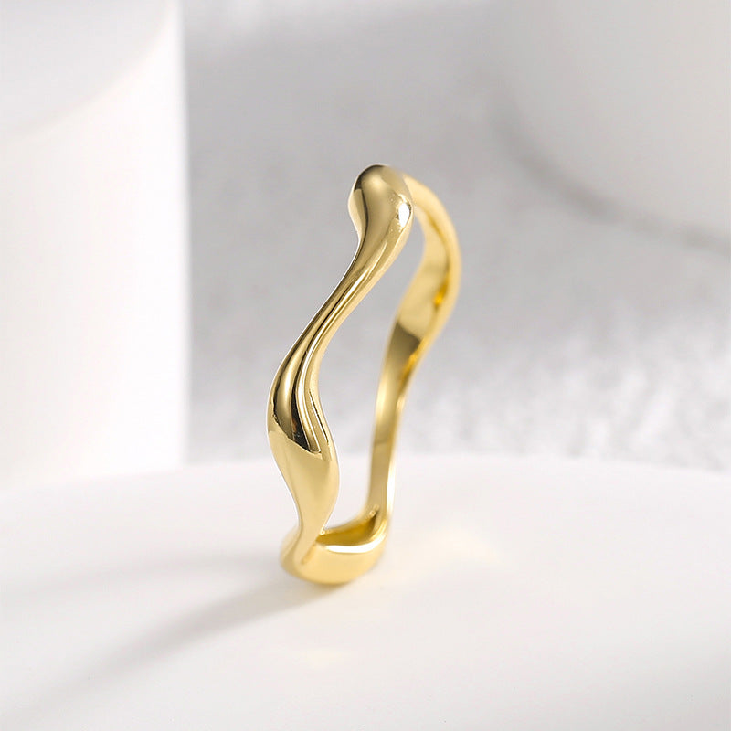 side profile showing the widened curves of the sculptural ring