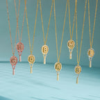 Letter-detail racket pendants hanging from chains
