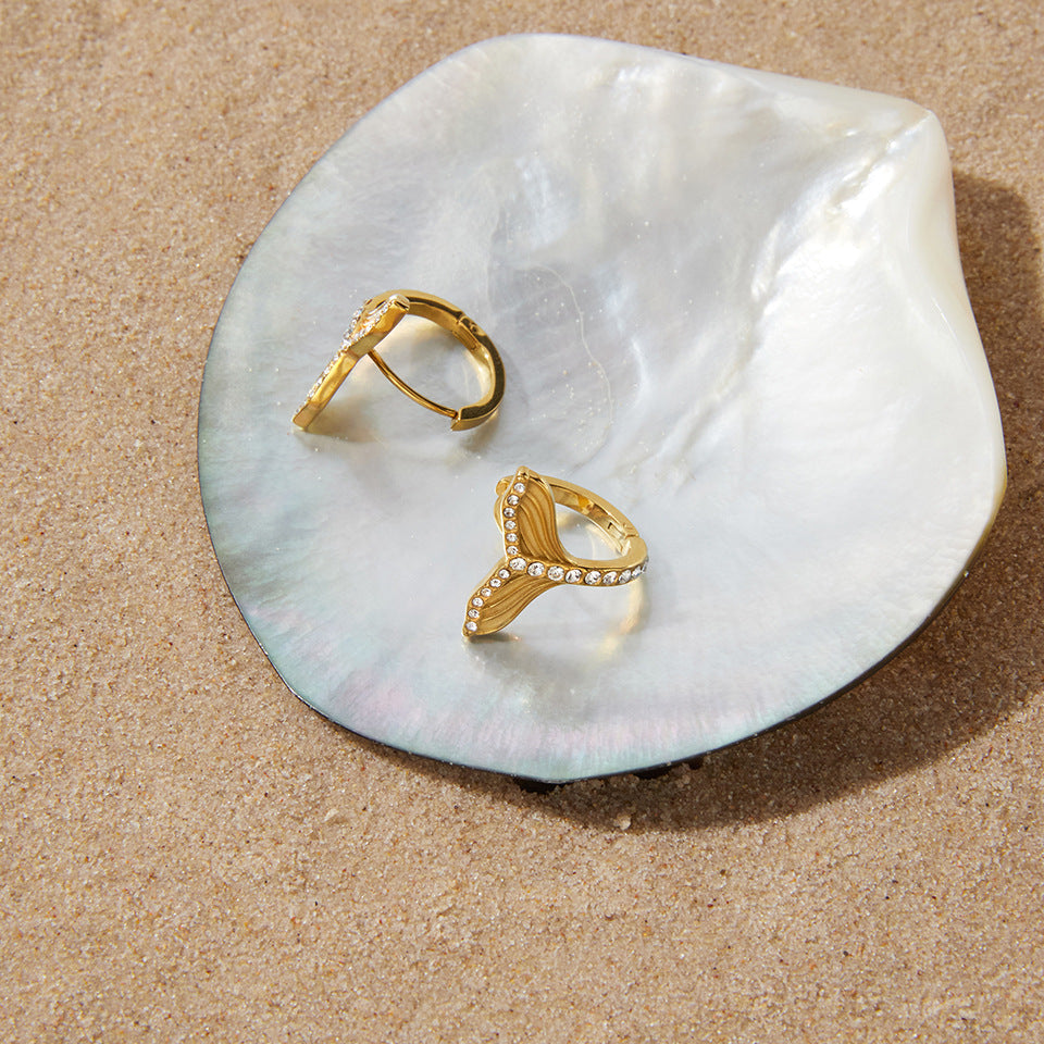 Mermaid tail hoops resting on a shell