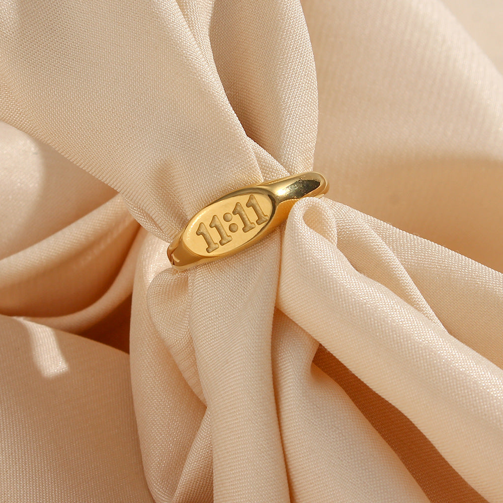 gold plated 11:11 oval signet ring styled on folded fabric