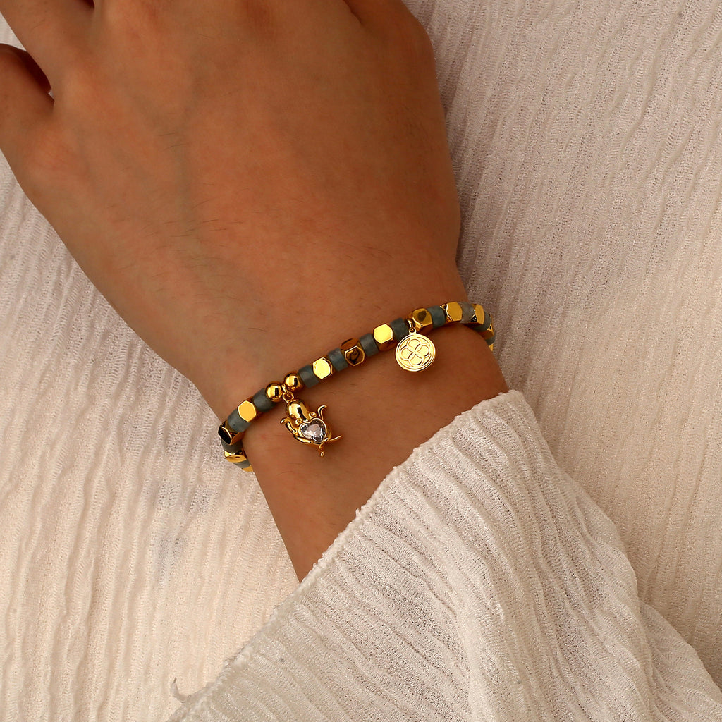 model wearing a sea turtle bracelet with heart-shaped clear stone