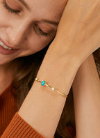 close wrist view of gold plated three-stone cuff bracelet