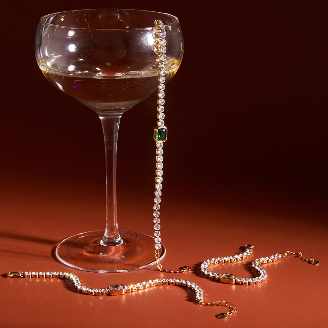 Clear stone bracelets displayed beside a glass