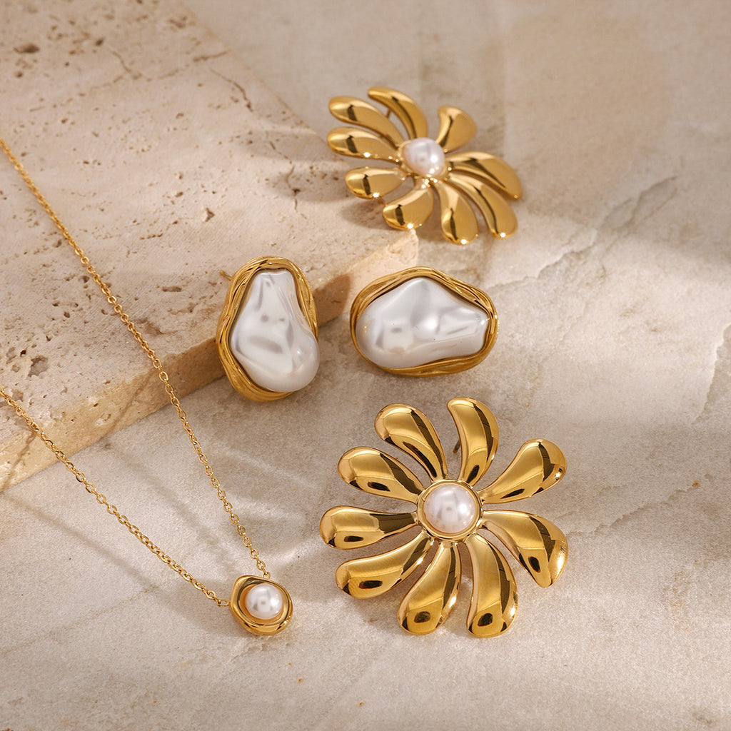 White-accent open ring and pendant necklace beside flower earring references