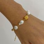 Mixed gold and baroque-look bead bracelet worn on a wrist