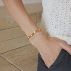 Gold-tone bracelets styled on the wrist