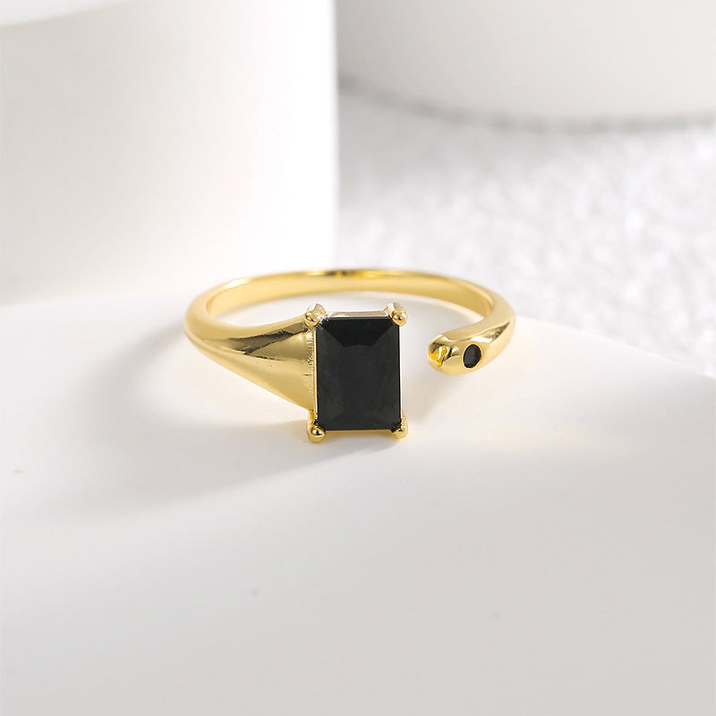 rectangular black stone open ring displayed on a white block