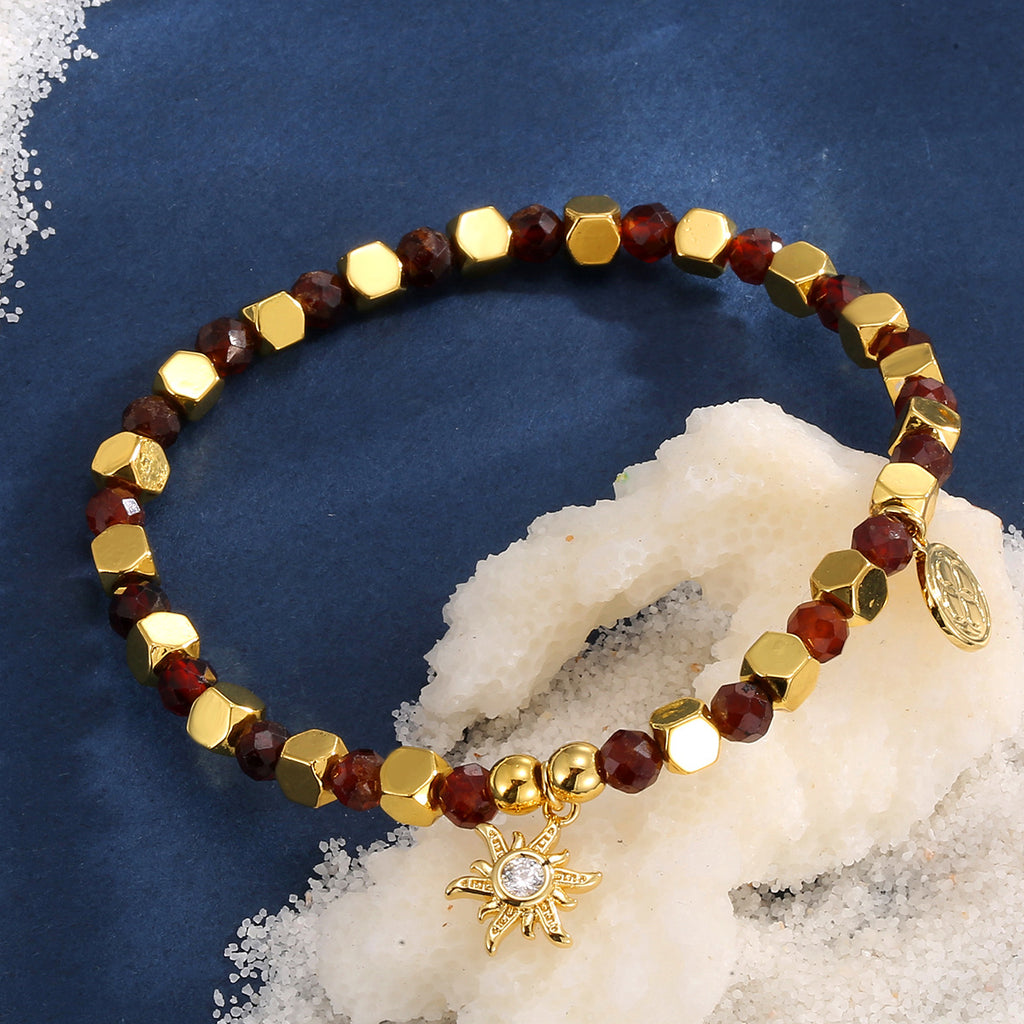 brown bead sunburst bracelet styled on blue fabric