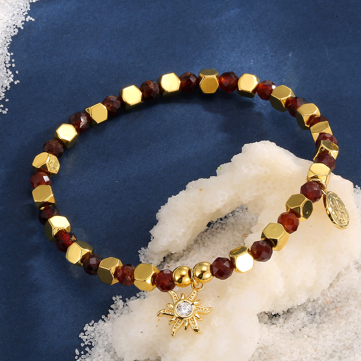 brown bead sunburst bracelet styled on blue fabric